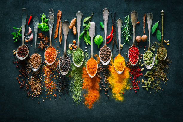 Colourful various herbs and spices for cooking on dark background Colourful various herbs and spices for cooking on dark background